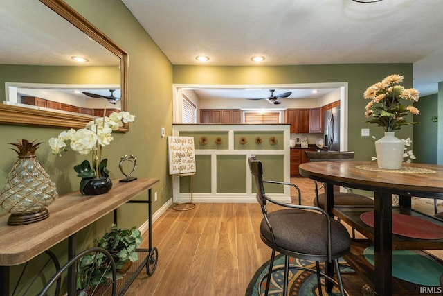 kitchen featuring a textured ceiling, ceiling fan, light hardwood / wood-style flooring, and stainless steel fridge