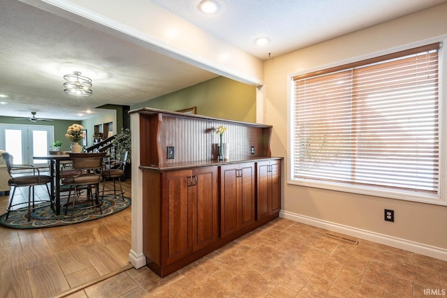 kitchen with a textured ceiling and ceiling fan