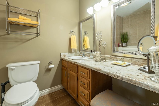 bathroom with toilet and vanity