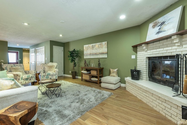 living room with light wood-type flooring and a fireplace