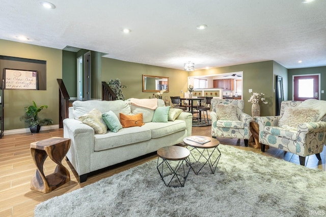 living room with a textured ceiling and light hardwood / wood-style floors