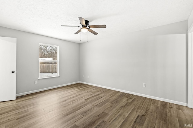 unfurnished room with a textured ceiling, ceiling fan, and hardwood / wood-style floors