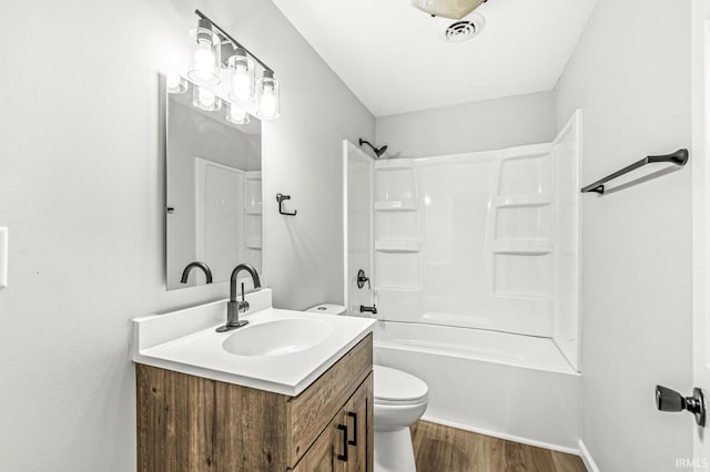 full bathroom featuring hardwood / wood-style floors, toilet, vanity, and shower / tub combination