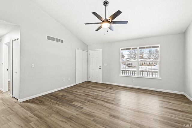 unfurnished room featuring ceiling fan, wood-type flooring, and high vaulted ceiling