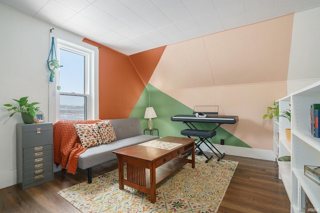 sitting room featuring dark hardwood / wood-style floors and vaulted ceiling