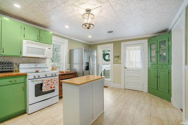 kitchen with crown molding, white appliances, green cabinetry, and wooden counters