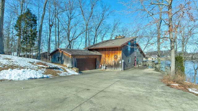 view of snowy exterior featuring a garage