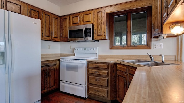 kitchen featuring sink and white appliances