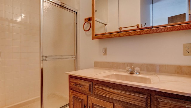 bathroom featuring an enclosed shower and vanity