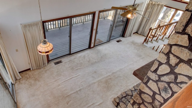 interior space featuring ceiling fan and light carpet