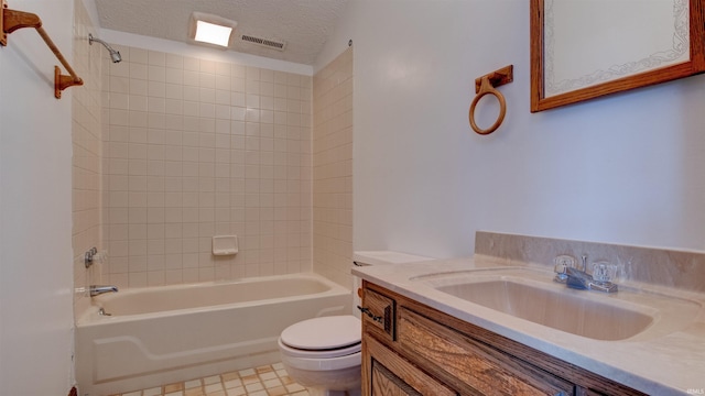 full bathroom featuring toilet, tiled shower / bath combo, tile patterned floors, a textured ceiling, and vanity