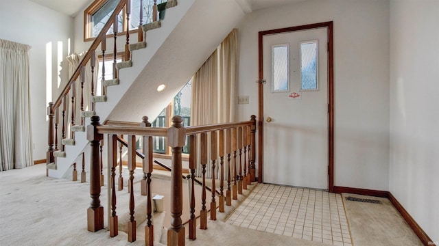 entryway with light carpet and plenty of natural light