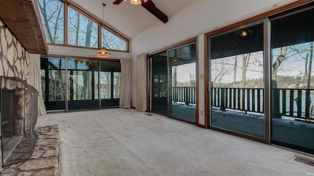 unfurnished sunroom featuring ceiling fan and vaulted ceiling with beams