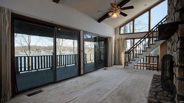 unfurnished living room featuring high vaulted ceiling, ceiling fan, and carpet flooring