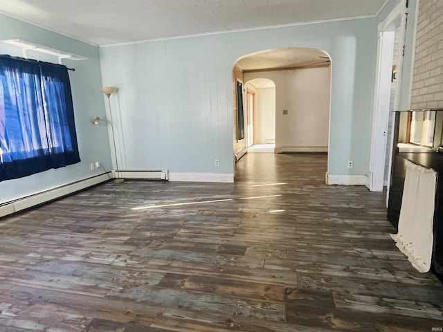 unfurnished room featuring a baseboard heating unit and dark hardwood / wood-style floors