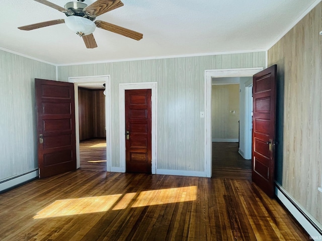 unfurnished bedroom featuring ceiling fan, crown molding, dark wood-type flooring, a closet, and a baseboard radiator