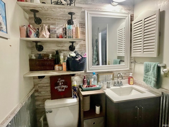 bathroom with toilet, radiator, and vanity