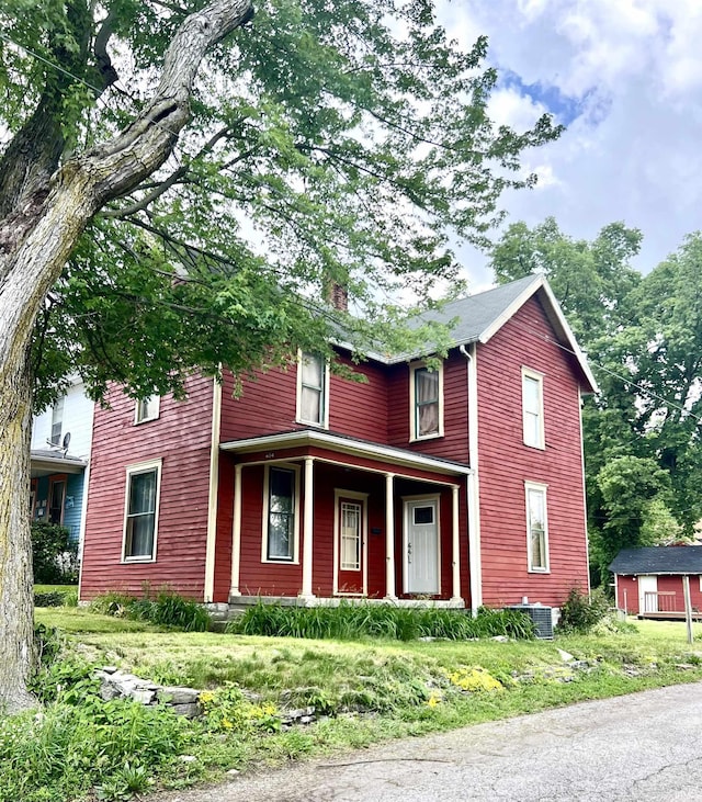 view of front of home featuring a porch and central AC