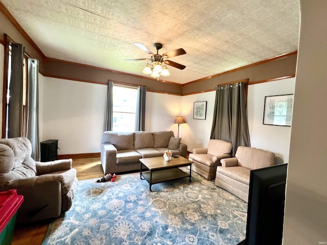 living room with ceiling fan, a textured ceiling, ornamental molding, and hardwood / wood-style floors