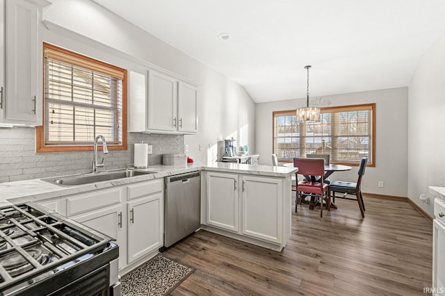 kitchen featuring white cabinetry, range with gas cooktop, kitchen peninsula, dishwasher, and sink