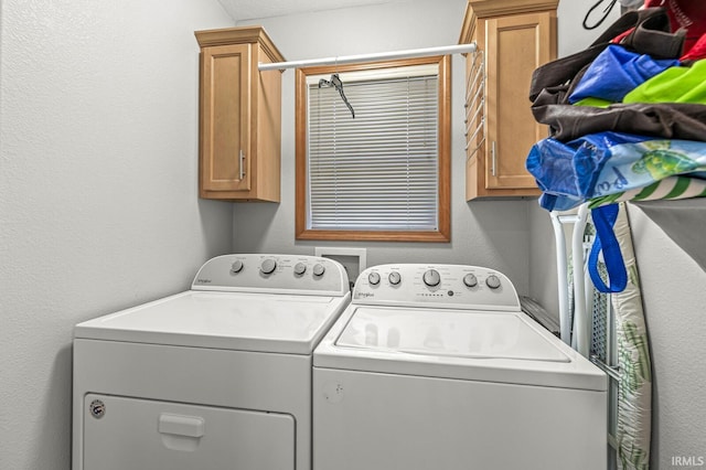 laundry room with cabinets and separate washer and dryer