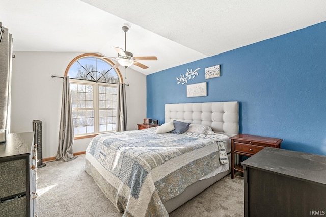 bedroom with vaulted ceiling, ceiling fan, and light colored carpet