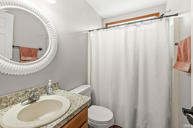 bathroom featuring toilet and vanity