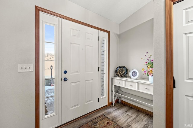 entrance foyer featuring wood-type flooring and a textured ceiling