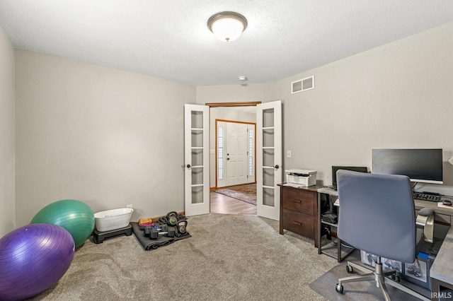 carpeted office space with french doors