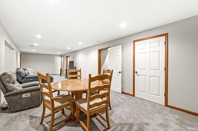 dining area featuring light colored carpet