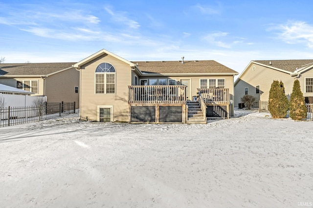 snow covered property featuring a wooden deck