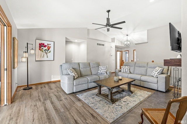 living room with vaulted ceiling, ceiling fan, and hardwood / wood-style floors