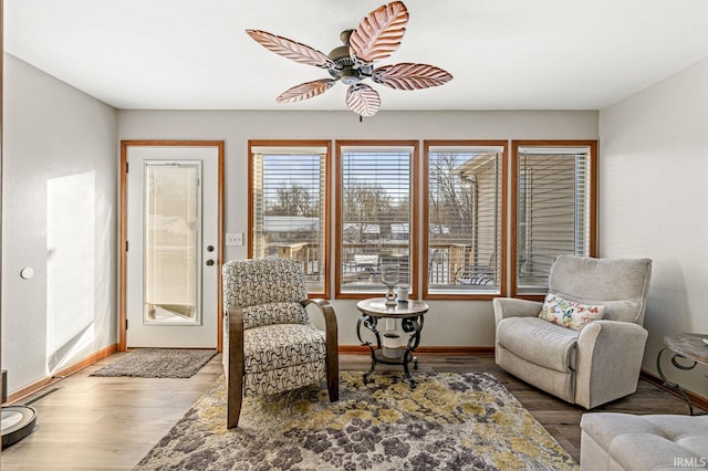 living area featuring ceiling fan and hardwood / wood-style floors