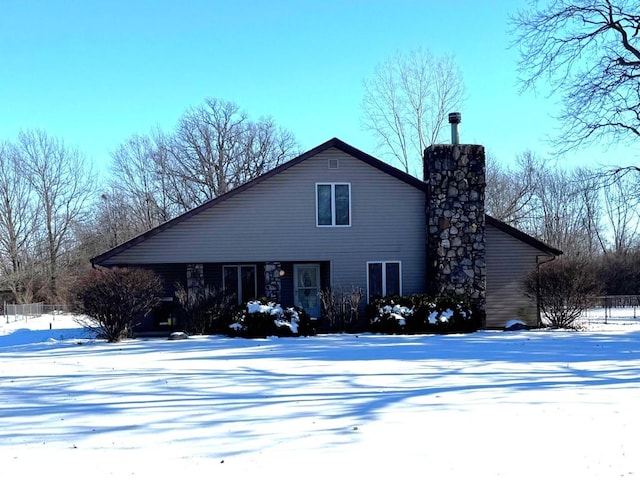 view of snow covered back of property