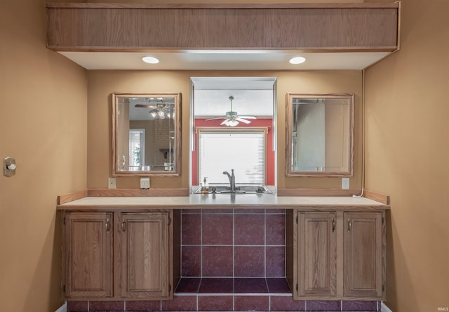 bar featuring ceiling fan and sink