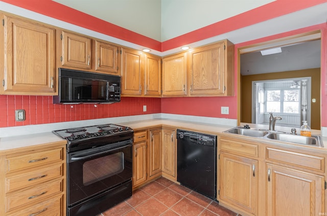 kitchen featuring black appliances, light tile patterned floors, and sink