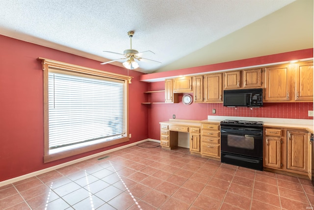 kitchen with ceiling fan, vaulted ceiling, black appliances, built in desk, and light tile patterned floors