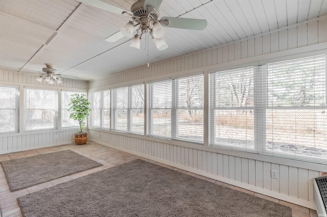 unfurnished sunroom with ceiling fan