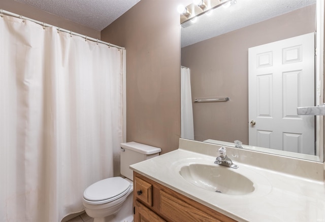 bathroom with a textured ceiling, toilet, and vanity