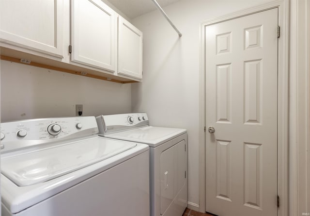 washroom with independent washer and dryer and cabinets