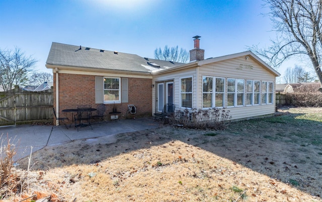 back of house featuring a patio area and a sunroom