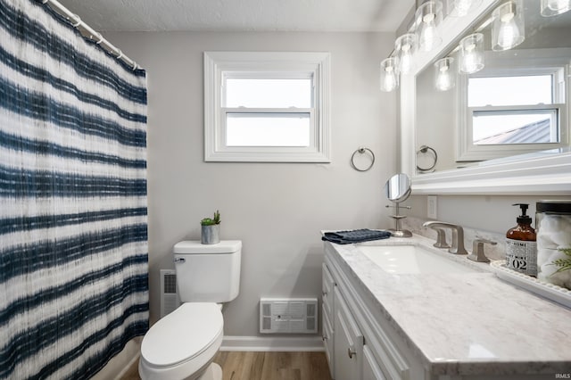 bathroom featuring toilet, hardwood / wood-style flooring, a textured ceiling, vanity, and curtained shower