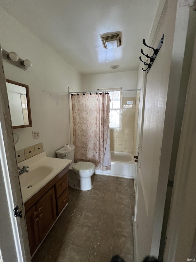 full bathroom with toilet, vanity, and shower / tub combo