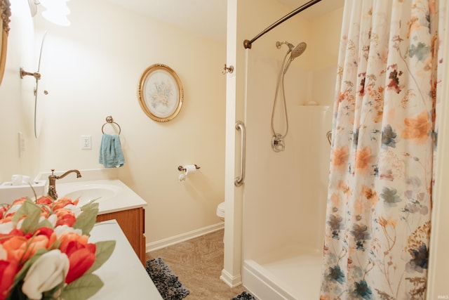 bathroom with vanity, toilet, and walk in shower