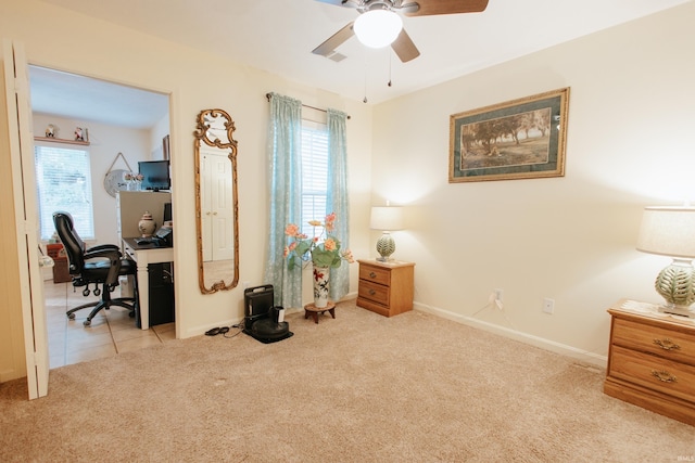 carpeted home office featuring ceiling fan