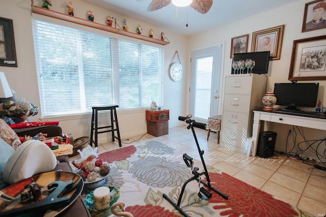 office featuring light tile patterned floors, a wealth of natural light, and ceiling fan