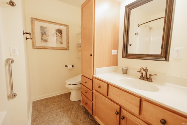 bathroom with a shower, toilet, and vanity