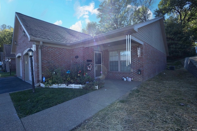 ranch-style house with a front yard and a garage