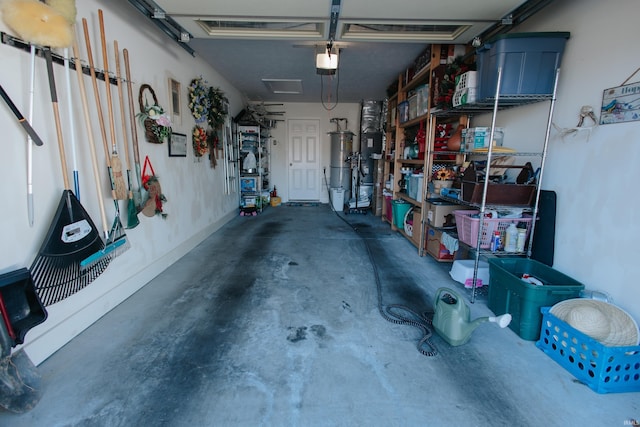 garage featuring a garage door opener and gas water heater