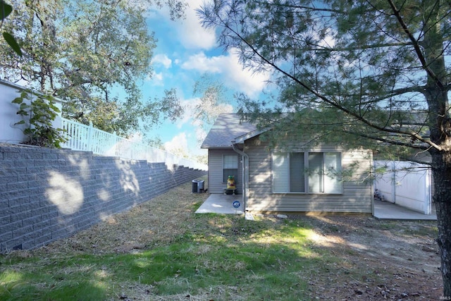 view of yard featuring a patio and central AC